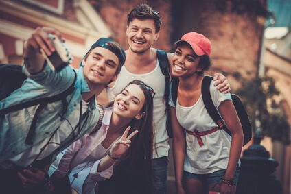Multiracial friends tourists making selfie in an old city